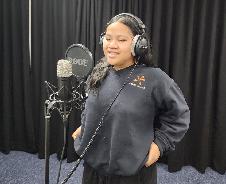 Female singing in recording studio.