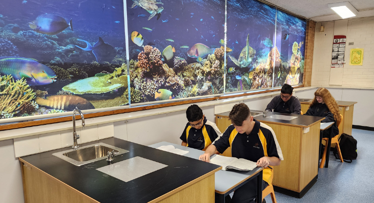 Students completing school work in science lab.