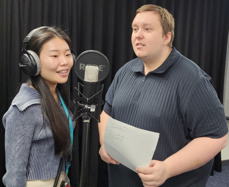 Staff using microphone in recording studio