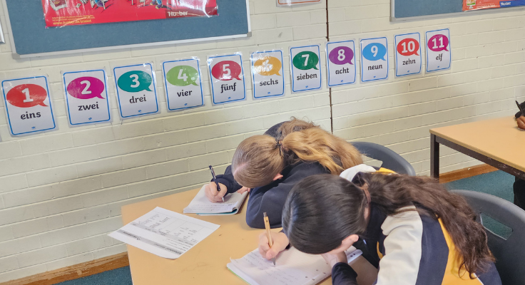 Students completing bookwork in language classroom.