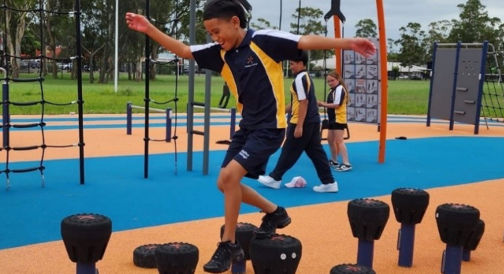Boy jumping over obstacles in Ninja Park.