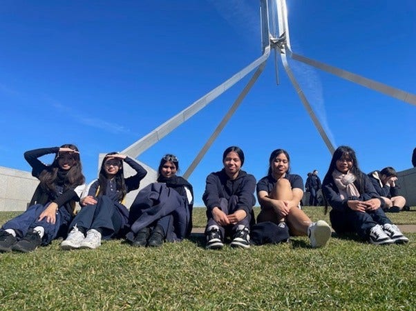Students sitting on Parliament Hill.