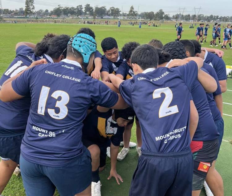 Photo of students in rugby scrum.