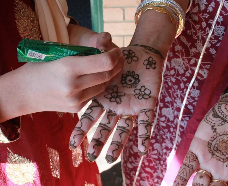 Henna design being drawn on hand